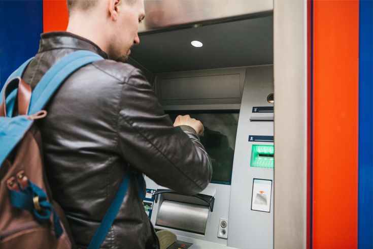 a man withdrawing money from lloyd's bank