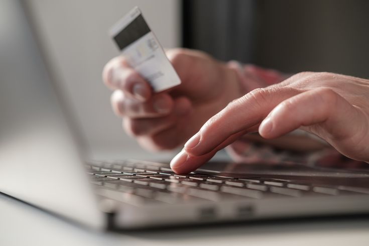 a man entering his bank details as part of a job scam