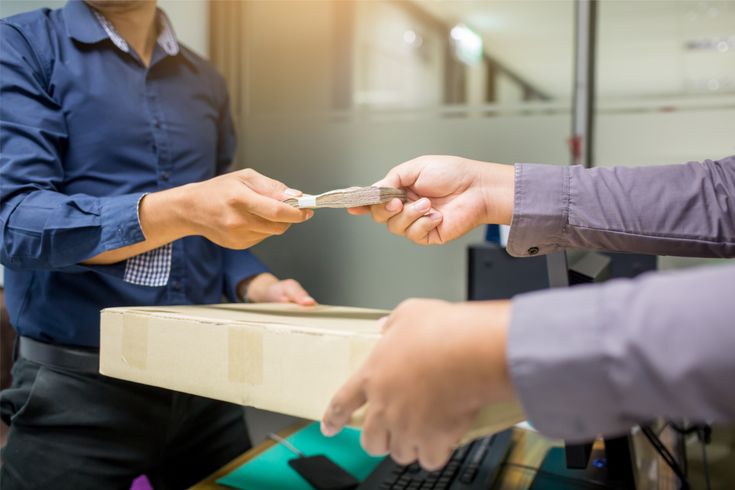 a man handing over money as part of santander bank fraud
