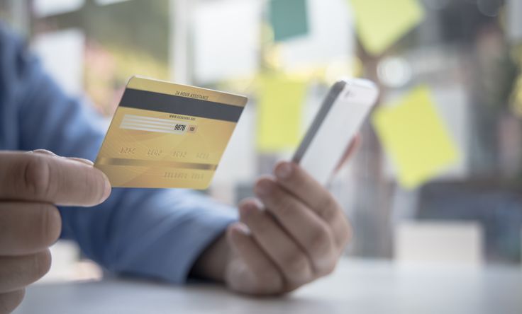 Man holding credit card and phone