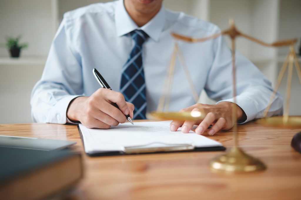 man writing on paper