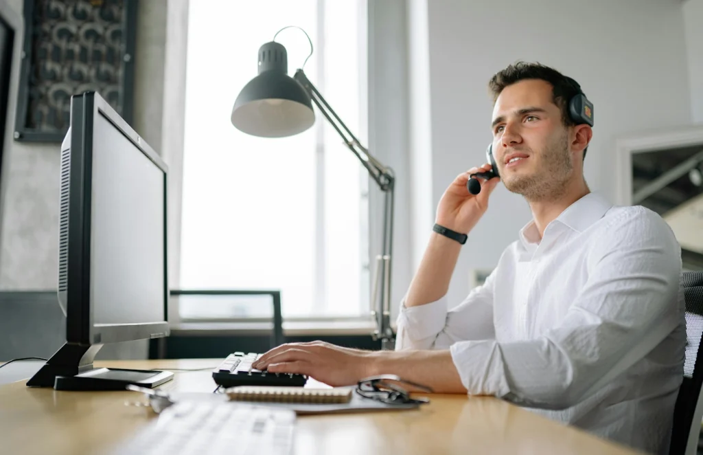A technical support engineer on the phone to a customer