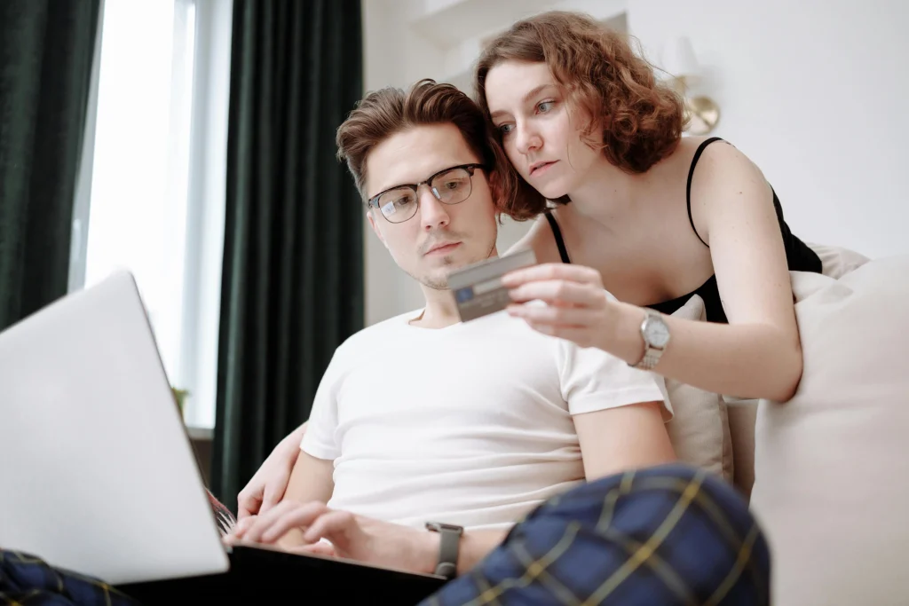 A couple reading their credit card statement online.
