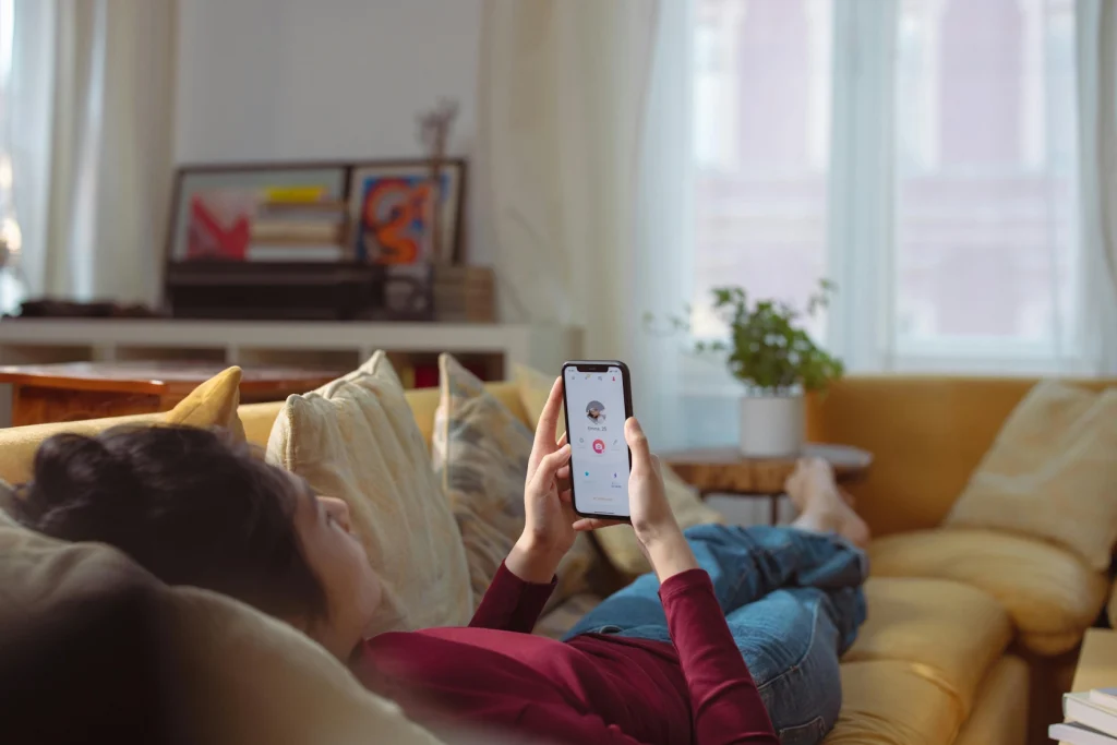 A woman looking at a dating app on her mobile phone.